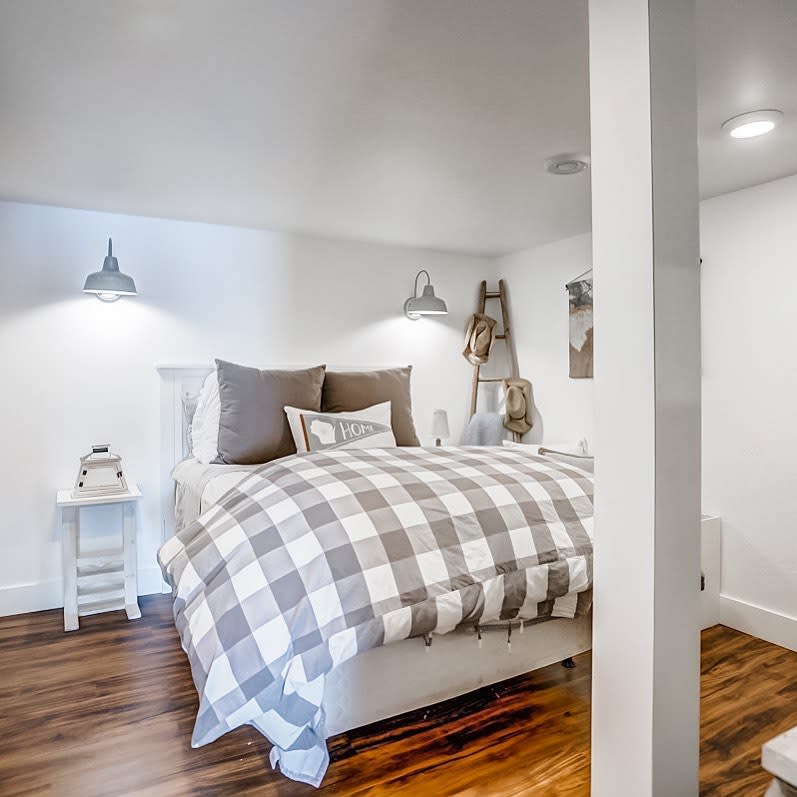 white bedroom with timber floors